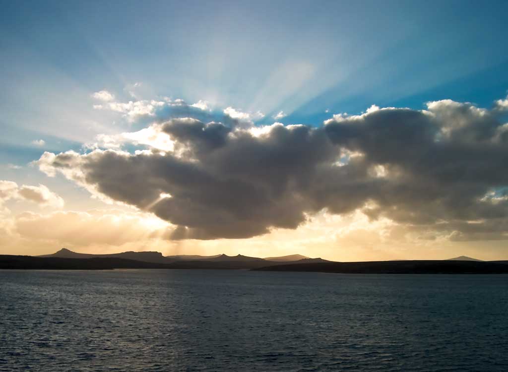 Clouds hiding the sun nearing dusk over the Falkland Islands