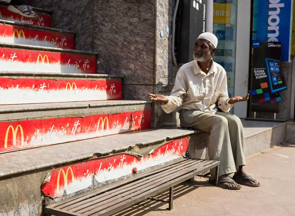 Waiting for spare change, food, or both outside of McDonalds on Brigade Road in Bangalore, India