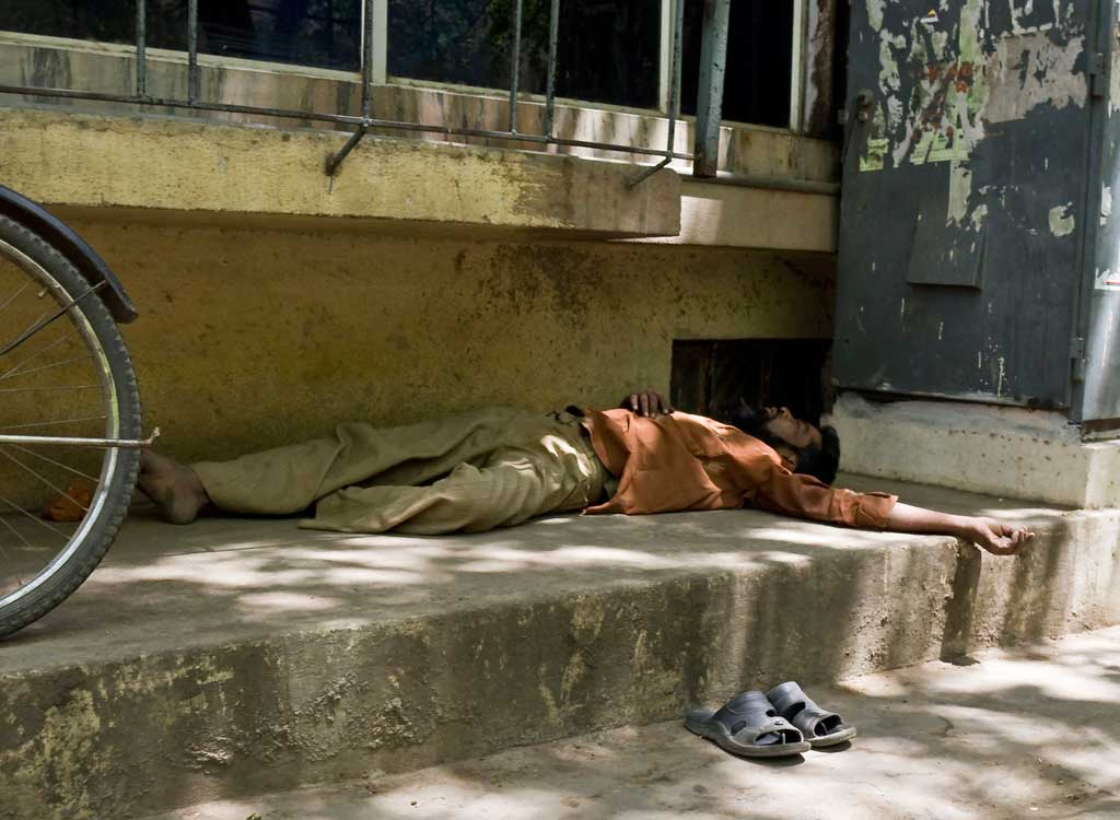 Man asleep on the pavement in Bangalore, India
