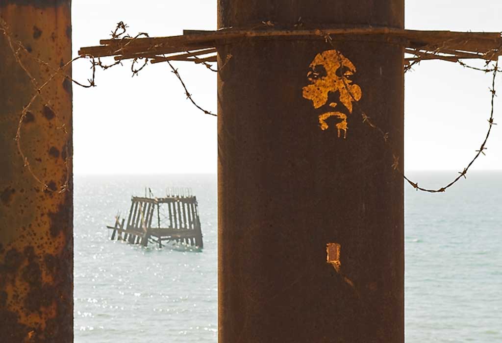 Graffiti in the rust on the collapsed pier in Brighon, Sussex