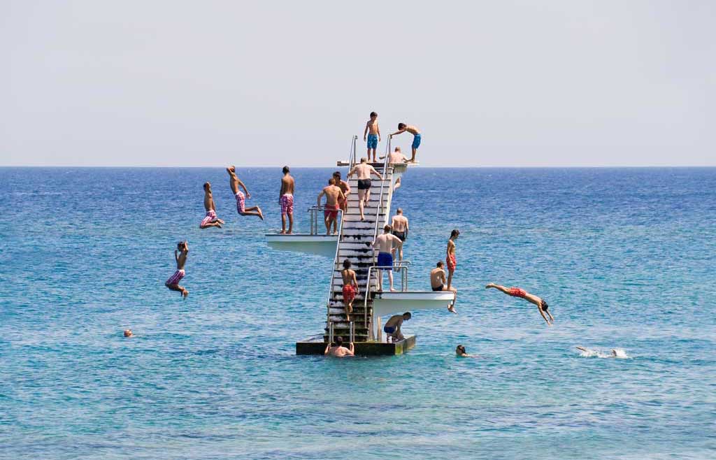 Peoplescape - People diving into the sea in Rhodes, Greece