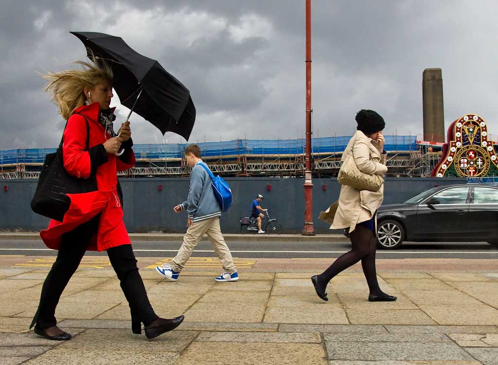 Street - people walking in the rain on Blackfriars Bridge in London