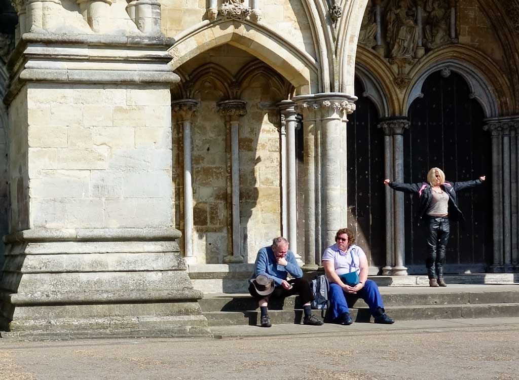 Street - woman posing outside Salisbury Cathedral, Wiltshire